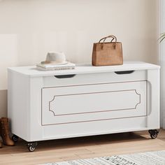 a white dresser with two drawers and a handbag on it's top shelf