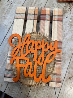 a wooden sign that says happy fall on it