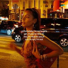 a woman standing in the street with her hand on her hip while looking at something