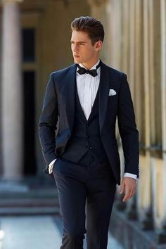 a man in a tuxedo is walking down the street