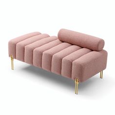 a pink couch sitting on top of a white floor next to a metal legrest