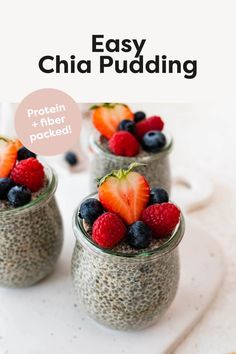 chia pudding with berries and strawberries in small glass jars on a white surface