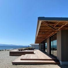 a wooden deck sitting on top of a sandy beach