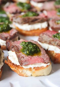 small appetizers with meat, cheese and sauces on them sitting on a white plate