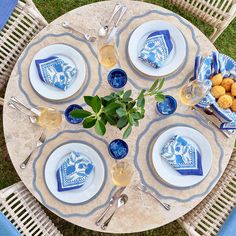 an overhead view of a table set with blue and white plates