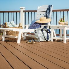 a white chair sitting on top of a wooden deck next to a blue and white bag