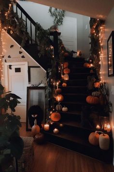 a staircase decorated for halloween with pumpkins and candles