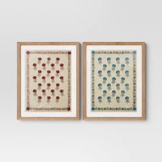 two framed art pieces with red and blue flowers