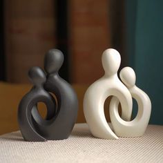 three ceramic sculptures sitting on top of a table