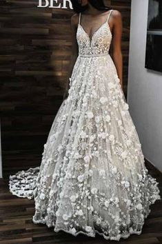 a woman standing in front of a wooden wall wearing a wedding dress