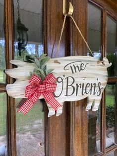 a wooden sign hanging from the side of a door