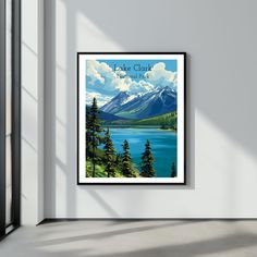 a poster hanging on the wall above a door in a room with a view of mountains and lake