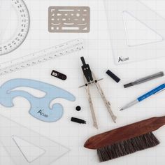 various tools are laid out on top of a sheet of paper with rulers, rulers and other items