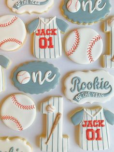 decorated cookies are arranged in the shape of baseballs and numbers for one, two, or three year olds