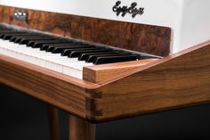 a close up view of the keys on an old fashioned piano with dark wood grained finish