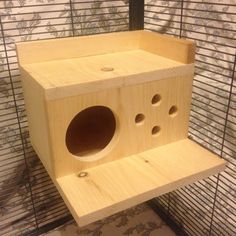 a wooden bird house with holes in it