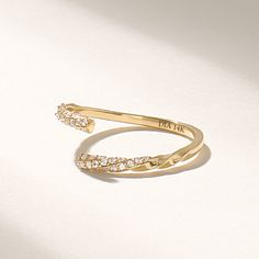 Introducing the exquisite real gold open band twisted ring, a stunning piece of jewelry that is sure to captivate anyone's attention. Crafted with precision and expertise, this pave diamond ring embodies elegance, sophistication, and timeless beauty. Made with genuine gold, this open band twisted ring showcases a modern twist on a classic design.  Features * Made to Order. * Gold KT: 10K, 14K, 18K * Custom Gold Color: Rose Gold, Yellow Gold, White Gold * Diamond Color-Clarity: D-E-F color VVS Clarity * Total CTW: 0.007ctw * Width of Band: 1.45 MM * Thickness of Band: 1.15 MM * Ready to Ship in 5-7 Business Days ✓ We care about the environment,the jewelry we cast is made with recycled gold. We source exclusively post-consumer material that is refined back to their pure elements to ensure th Open Cuff Engagement Ring, Luxury Engraved Open Band Ring For Wedding, Modern Twist Open Ring Jewelry With Diamond Accents, Modern Twist Gold Diamond Ring For Anniversary, Gold Diamond Ring For Anniversary With Modern Twist, Modern Twist 14k Gold Bypass Ring For Anniversary, Modern Twist Diamond Ring With Open Band For Anniversary, Fine Jewelry Bypass Ring For Promise, Fine Jewelry Bypass Open Ring For Promise