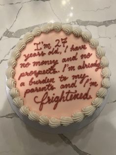 a cake with writing on it sitting on a table