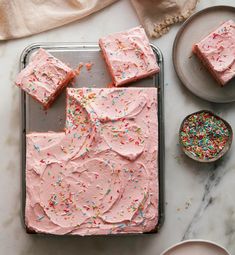 pink frosted cake with sprinkles on a tray