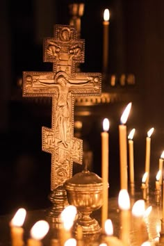 the cross is surrounded by lit candles