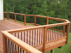 a wooden deck with rails and railings