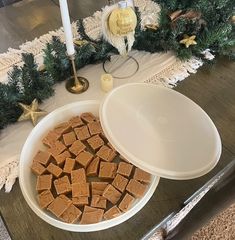 a bowl filled with fudge next to a plate full of fudge