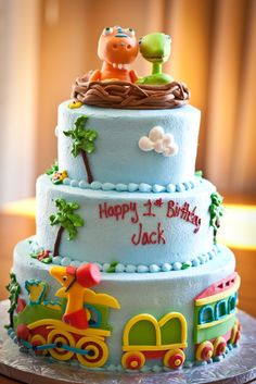 a birthday cake with animals and train decorations