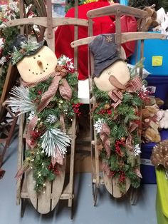 two wooden sleighs with christmas decorations on them