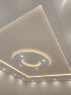 the ceiling in this room is made of white plaster and features recessed lighting, along with dimmers