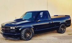 a black truck parked in front of a building