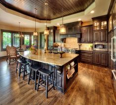 a large kitchen with an island in the middle