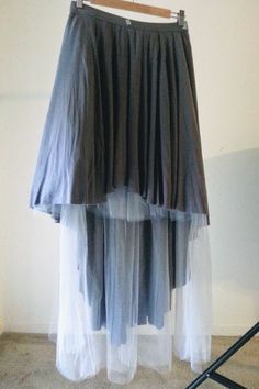 a skirt hanging on a hanger in a room