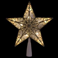 a lighted christmas star hanging from the side of a pole in front of a black background