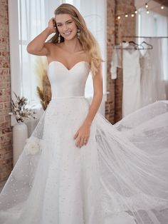 a woman in a wedding dress posing for the camera