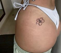 a woman with a flower tattoo on her stomach