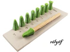 a toothbrush holder with seven green brushes in it and the words, keep on them