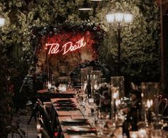 a long table is set up with candles and place settings for an elegant dinner party