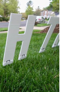 the letters h and h are placed in the grass near each other on the lawn