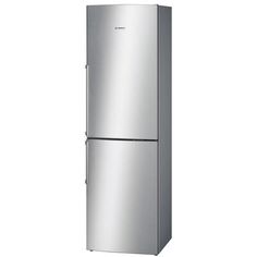 a silver refrigerator freezer sitting on top of a white wall