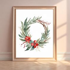 a watercolor painting of a wreath with red berries and green leaves on the front