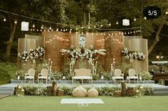 an outdoor wedding setup with chairs and lights