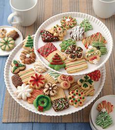 decorated cookies are arranged on two white plates