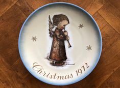 "Schmid Bros produced its collectible Hummel Christmas plate series collectible between 1971 and 1992. The plates are based on the art work of Sister Berta Hummel.  This listing is for the second plate in the series, issued for 1972.  The art on this plate is titled \"Engel mit Flote\" (Angel With Flute).. The 7-3/4\" plate is in very good vintage pre-owned condition.  No box. I have other plates available from this series. l offer for sale a wide variety of china, dinnerware and pottery. I hope you'll spend some time browsing through the selection in my shop. http://www.etsy.com/shop/JosChinaShop L1022" Wedding Cake Plates, Spring Tea, Christmas Plate, China Cups And Saucers, Dessert Bread, Christmas Plates, Packing Peanuts, China Patterns, Collectable Plates