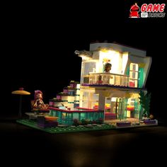 a lego lit up house in the dark