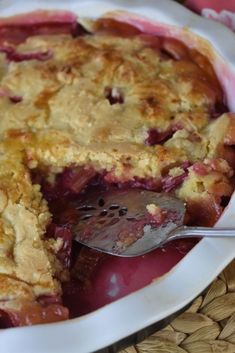 a close up of a pie on a plate with a fork in it and a piece missing from the pie