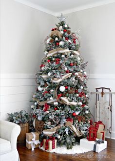 a christmas tree decorated with ribbon and ornaments