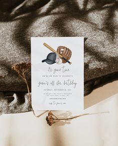 a card with a baseball bat and ball on it next to a t - shirt