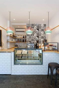 the interior of a bakery with white brick walls