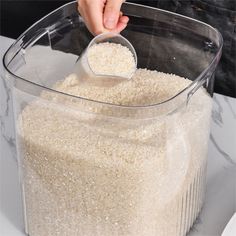 a person scooping rice into a container