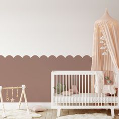 a baby's room with a crib and pink walls